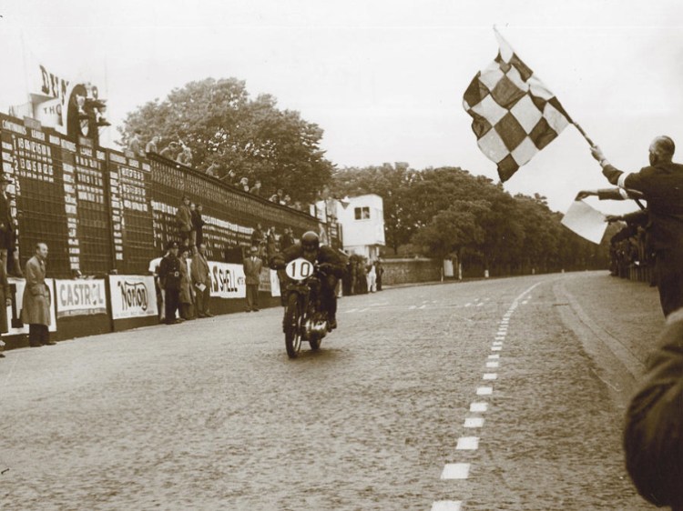 Alex Phillip hitting the finish line as the winner at an average speed of 78.58mph with his stock 1947 Rapide for this second edition of the Clubman TT. | Picture courtesy of Mortons Archives