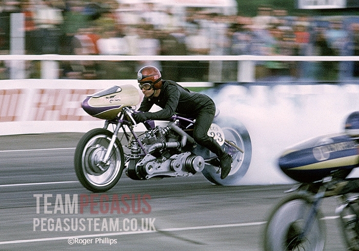 “Another great action shot from Roger Phillips showing Mick Butler on the Pegasus-Vincent employing his neat "economical" riding style with the nosecone of arch rival John Hobbs just coming into shot. 1971 Santa Pod Raceway, UK”. Information TeamPegasus and picture © Roger Phillips