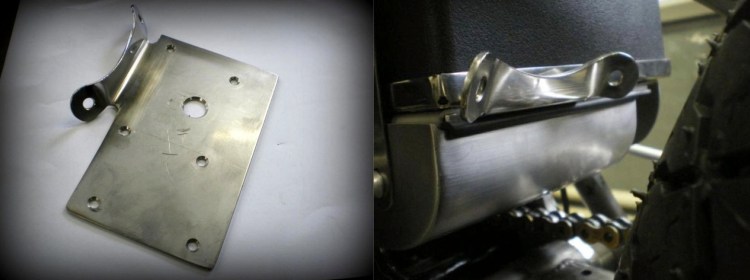 The rear fender bracket fixed between the battery tray and the fuse box.