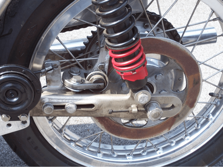 Photo of the rear Campagnolo mechanical single disc. The disc can be positioned on the disc by the two bolts through the swing arm on the left. Often owners extend or add welds to the lever arm to get better braking. Credit: David Dunfey